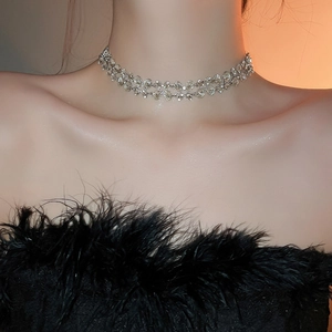 Close-up of double-layer silver necklace with sparkling rhinestones on model neck