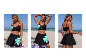 Detail of high-waist bikini with green tropical floral skirt and metal ring accent