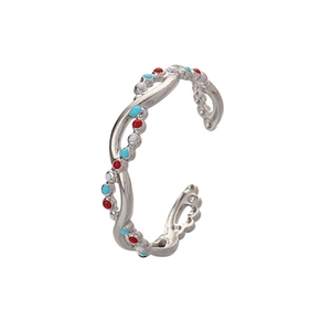 Detail of silver twisted band ring with colorful enamel inlay and hollow leaf patterns