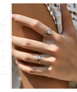 Close-up of model wearing stacked S925 silver rings with teardrop and oval cubic zirconia