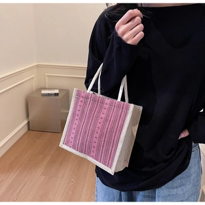 Close-up of pink and purple striped linen tote bag with white cotton rope handles