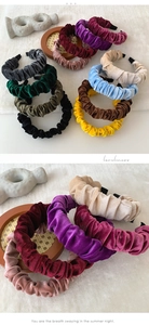 Detail view of colorful pleated velvet headbands in various elegant solid shades