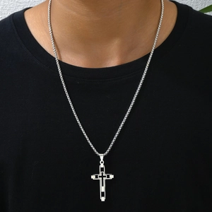 Modern hollow silver stainless steel cross pendant necklace worn by a male model