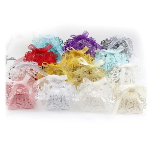Detail of laser-cut butterfly candy boxes with matching ribbon bows in various colors