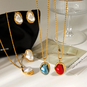 Detailed close-up of Baroque pearl jewelry set featuring twisted gold chain necklaces