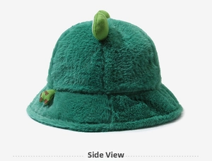 Detail showing the dinosaur back fin design on the fluffy green plush fisherman hat