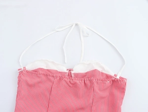 Detail of red and white striped dress featuring delicate lace trim and thin spaghetti straps