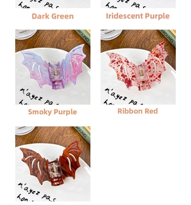 Detail of bat-shaped hair claws in purple, red, and marble patterns on a ceramic plate