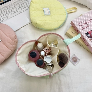 Quilted shell cosmetic bag with internal dividers for makeup storage and organization