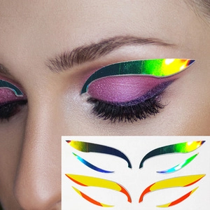 Macro shot of colorful reflective rhinestone eyeliner stickers on a female model eye