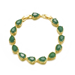 Detailed macro view of pear-shaped green gemstones set in elegant golden bracelet