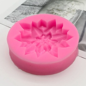 Pink food-grade silicone mold with intricate Christmas poinsettia flower pattern for baking