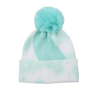 Detail of the tie-dye knit beanie texture and fluffy faux fur pompom in mint green