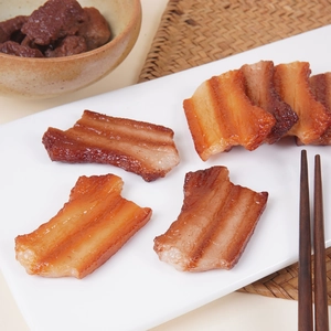 Realistic PVC pork belly model with glossy texture on a white plate for food props