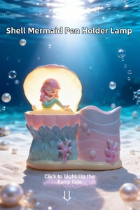 Close-up of shell mermaid pen holder lamp with warm lighting and resin textures