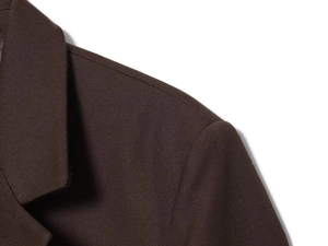 Detailed macro view of dark brown blazer shoulder seams and woven fabric texture