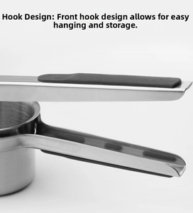 Detail of stainless steel potato masher with ergonomic non-slip handle and storage hook