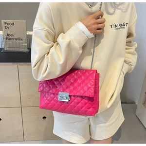 Detail of rose pink quilted chain bag with silver twist lock and luxury embroidery