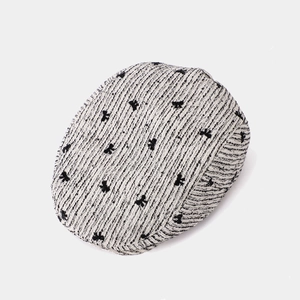 Chic tweed beret with black bow embroidery on a textured white fabric finish