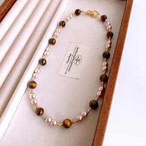Vintage tiger eye and pearl beaded necklace with golden OT buckle in a jewelry box