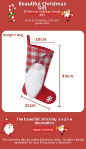 Close-up of a red Christmas gnome stocking with snowflake embroidery and a grey plaid cuff