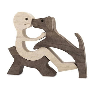 Detail of wooden sculpture showing a warm interaction between a person and a dog