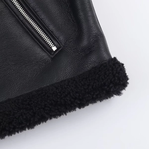Detail of premium black leather jacket showing metal zipper and soft faux fur trim