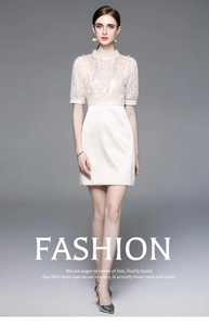 Close-up of elegant cream dress with lace embroidery and pearl beaded collar detail