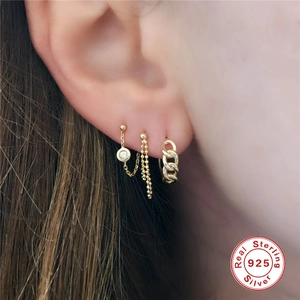 Three-piece set of minimalist S925 sterling silver gold chain earrings worn by a model
