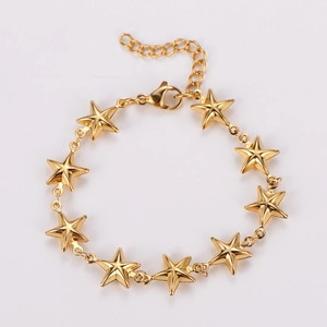 Close-up of a gold star charm bracelet with adjustable lobster clasp and polished finish