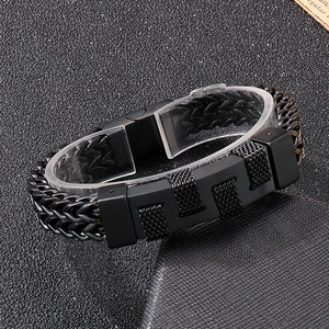 Detail of black woven leather and metal link bracelet for men with magnetic clasps