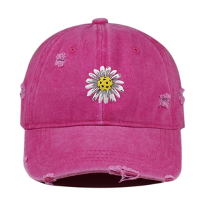 Detail of rose red distressed cotton baseball cap with white daisy embroidery