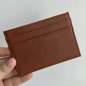 Close-up of brown Saffiano leather slim card holder showing three credit card slots