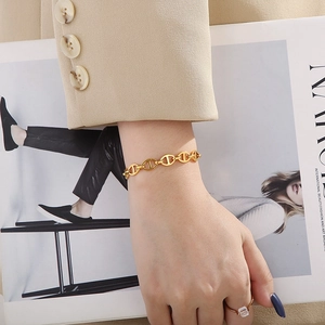 Elegant gold-tone stainless steel anchor chain bracelet for women in a luxury minimalist style