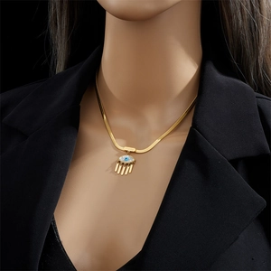 Gold snake chain necklace featuring evil eye pendant with lucky plaque and tassel fringe