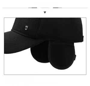 Close-up of black winter knit baseball cap with ear flaps and SPORT logo label