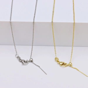 Detail of adjustable 18k gold and silver necklace chains with lobster clasp and slider
