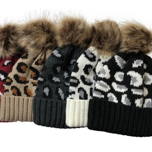 Women leopard print knitted beanies with large faux fur pompom in various colors