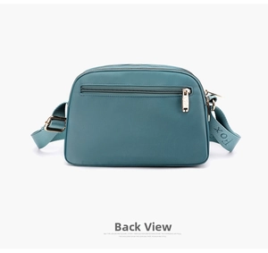 Detail view of the back zipper pocket and wide jacquard FOX logo strap on nylon bag