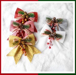 Detailed close-up of glitter Christmas bows with pine cones and berries in five colors