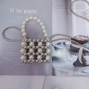 Mini beaded bag featuring white pearls and silver metal beads with crossbody chain strap