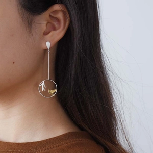 Close-up of S925 sterling silver dangle earring featuring golden bird and willow branch