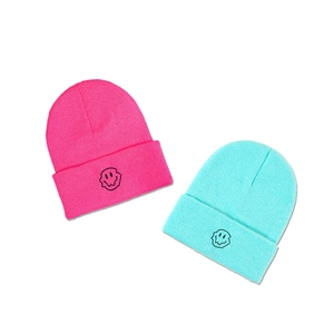 Fashionable ribbed knit beanie with embroidered crying face in pink and blue