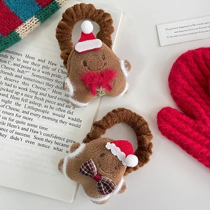 Plush gingerbread man hair scrunchies with festive bows and Christmas hats