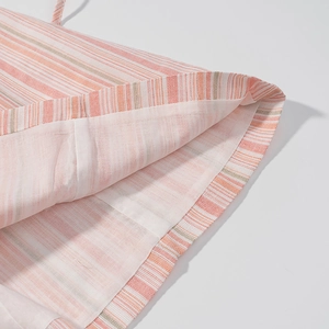 Close-up of pink and white striped cotton-linen fabric texture with inner lining detail