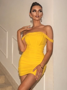 Detail of yellow bodycon slip dress with corset bodice and ruched fabric texture
