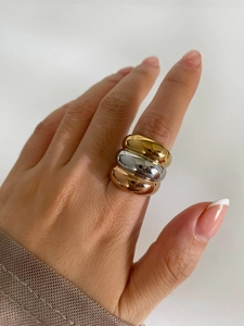Detailed view of triple-color stacked rings with 18k gold, silver, and rose gold finish