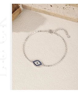 Detail of S925 sterling silver evil eye bracelet with blue zircons and lobster clasp