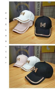 Detailed close-up of rhinestone M logo and diamond edge on black, white, and pink caps