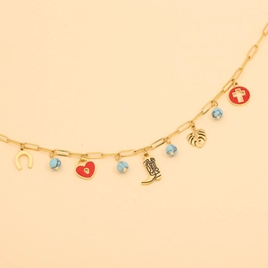 Detail of gold chain necklace featuring cowboy boot, heart lock and horseshoe charms